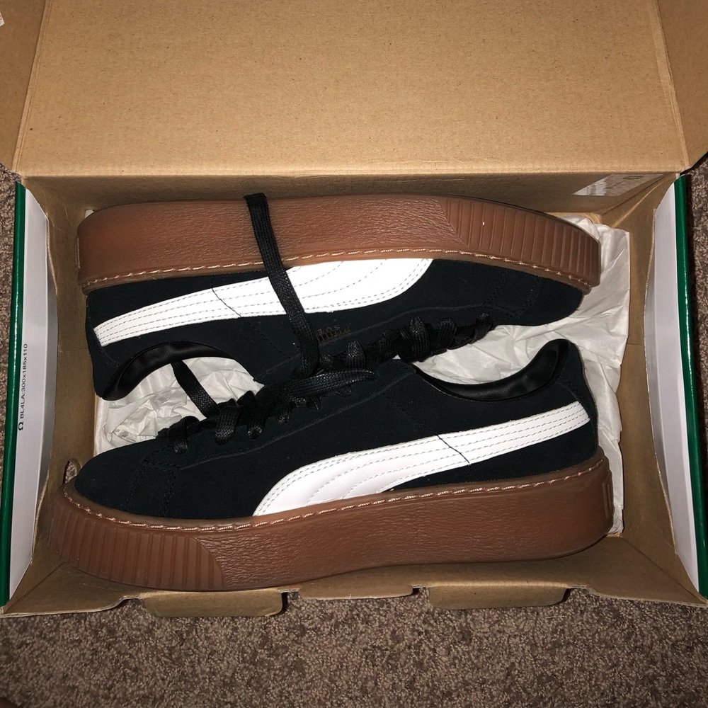 black and white suede pumas with tanish sole.